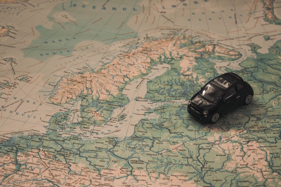 A car toy on a world map. 